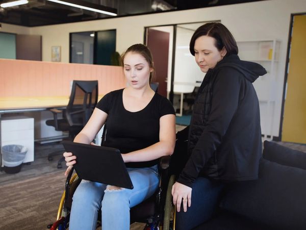 Two women reviewing a tablet together