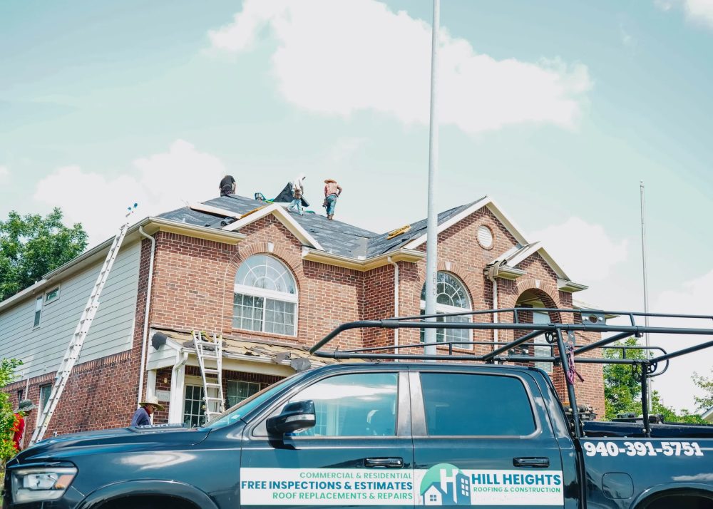 Hill Heights crew and branded truck on site at a two-story brick home