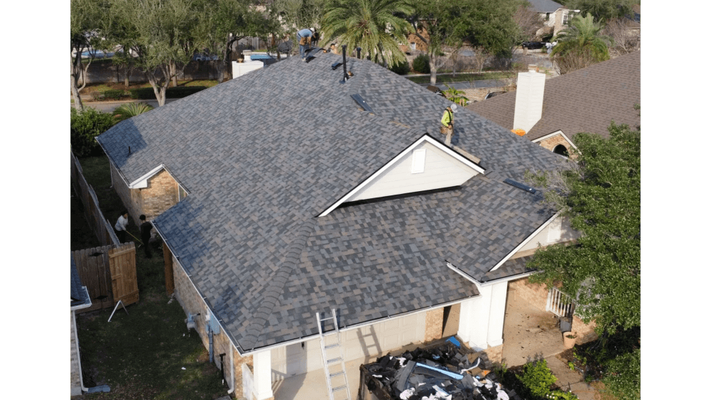 Completed roof replacement on a single-story home with mature trees
