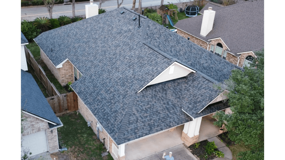 Finished shingle roof photographed from the air in a Texas neighborhood