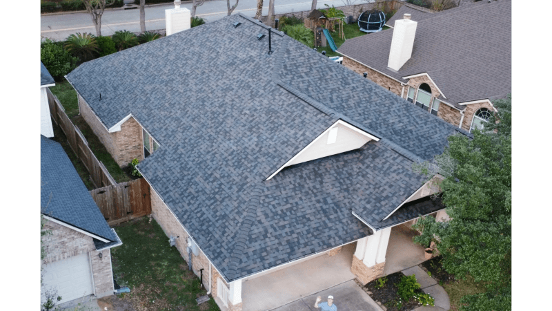 Finished shingle roof photographed from the air in a Texas neighborhood