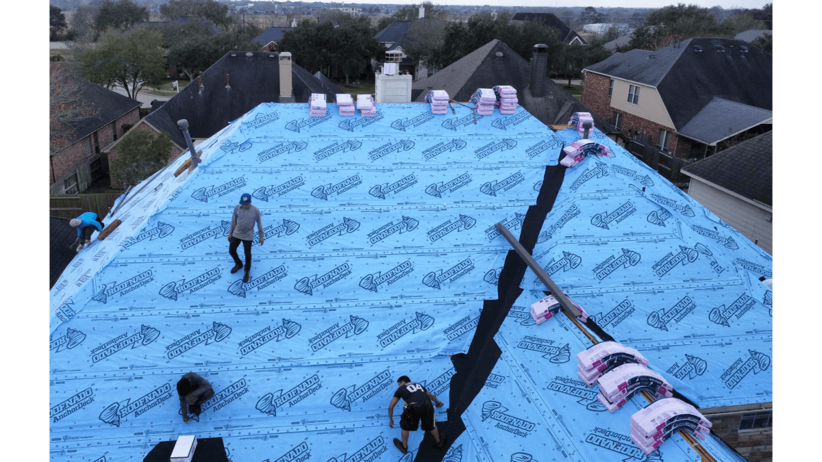 Hill Heights crew installing underlayment on a roof deck