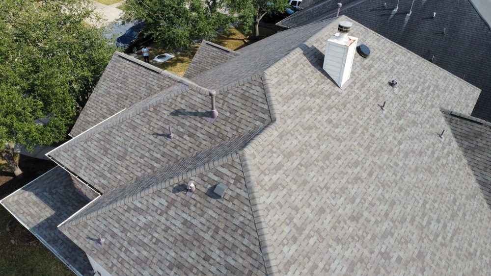 Completed roof seen from above with clean valleys and flashing