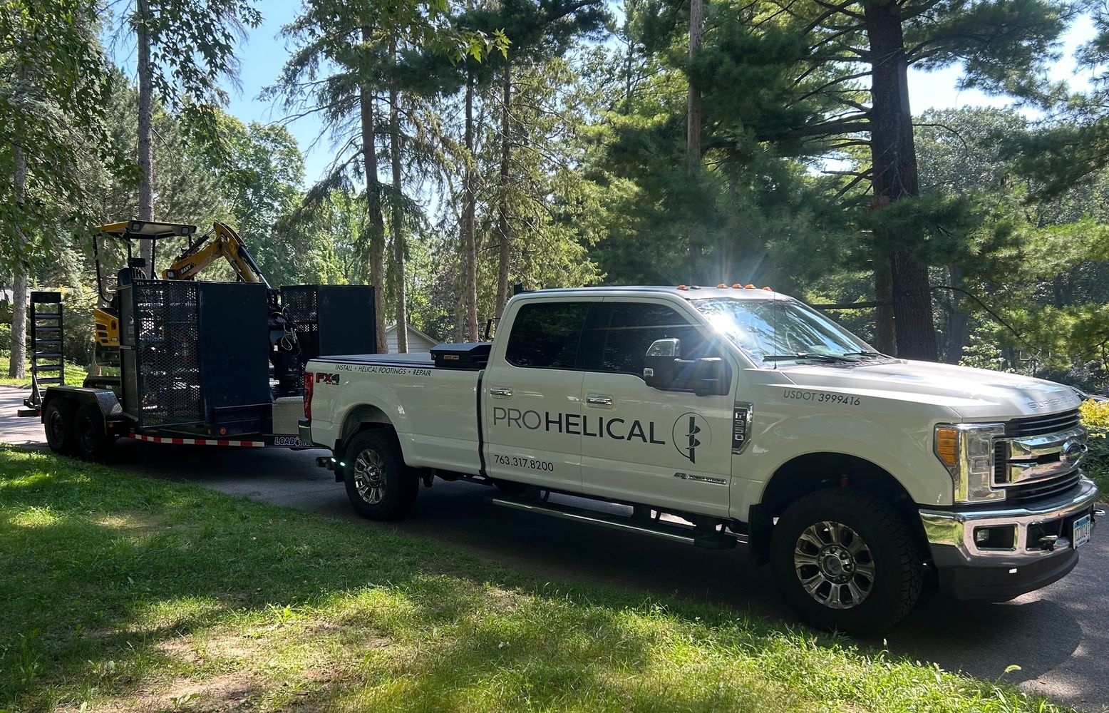 white Ford truck hauling helical equipment - Pro Helical helical piers