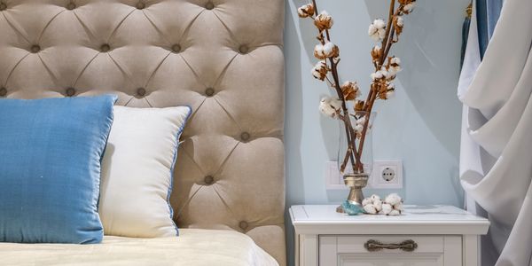 Staged bedroom with floral arrangement