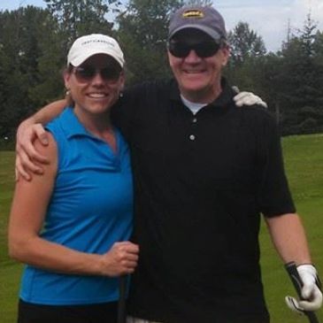 A man and a woman in a golf course