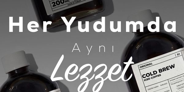 Bottles of original cold brew iced coffee with clear labels on a gray surface.