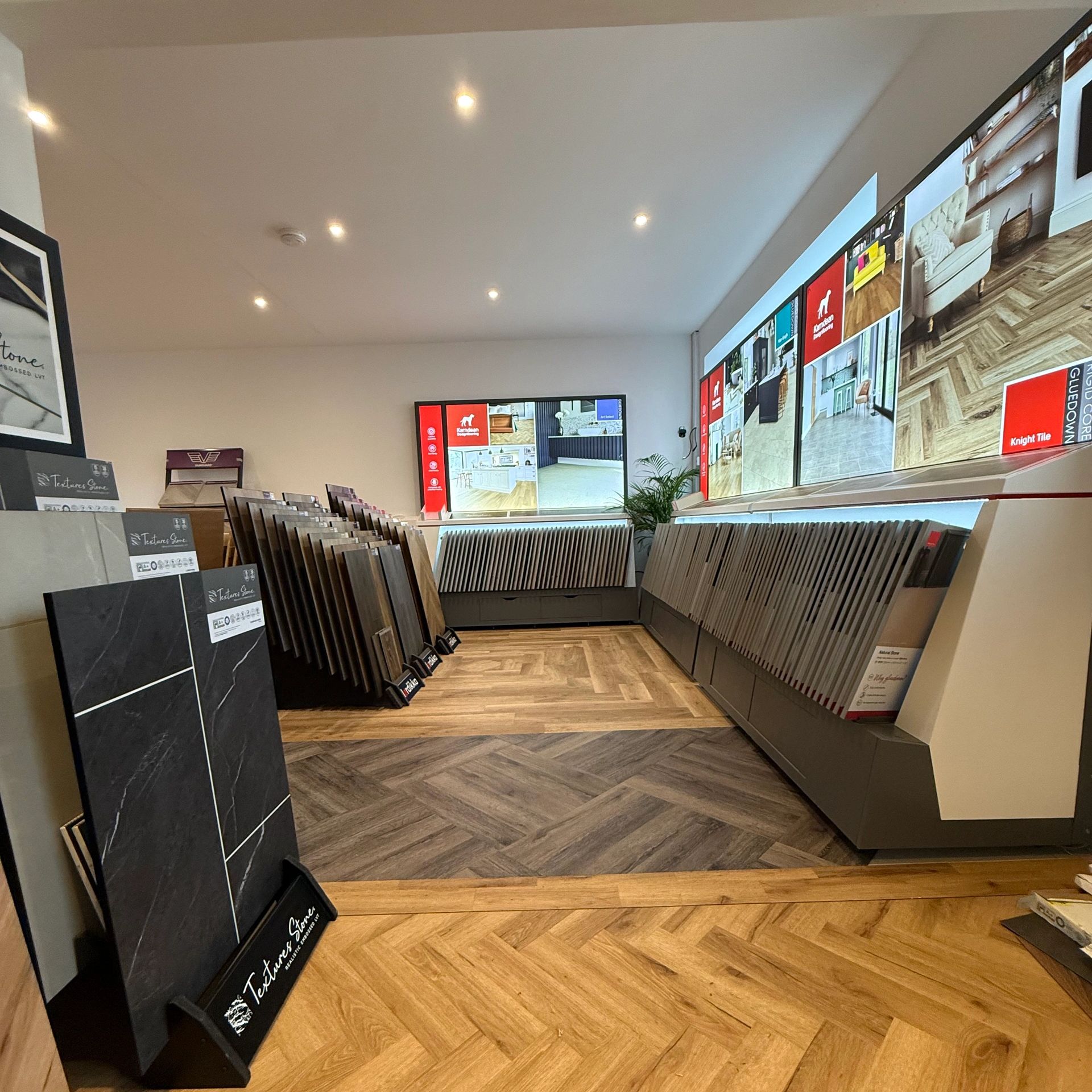 Flooring showroom with digital displays.