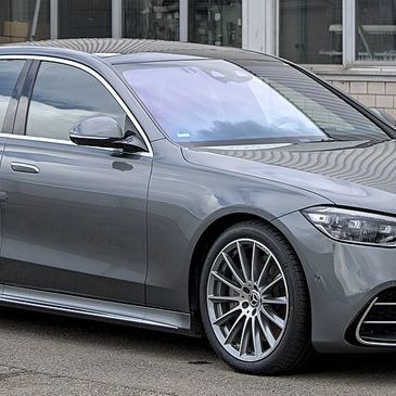 Sleek silver luxury sedan parked on a city street.