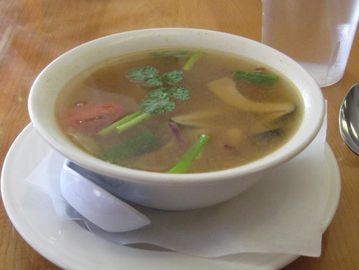 Mushroom, onion, green onion and tomato in lemongrass broth.