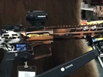 Close-up of a detailed rifle with attachments.