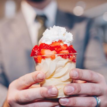 Pineapple Dole Whip topped with fresh strawberries and whipped cream. Heavenly!