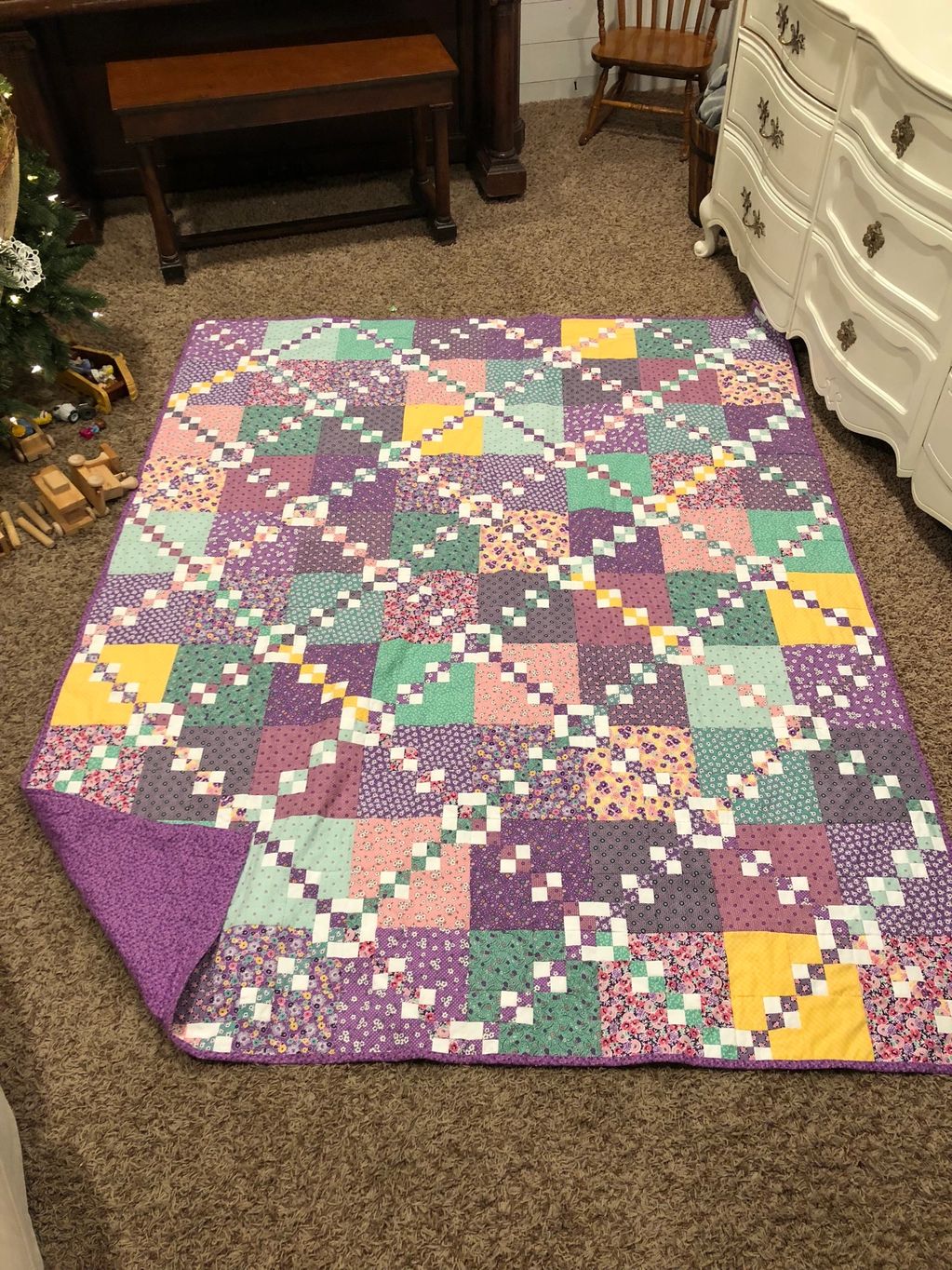 quilt that is pink and purple with yellow accents that is spiced together and hand quoted with free 
