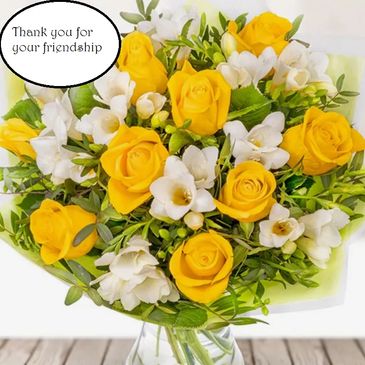 A bouquet of yellow roses and white flowers with a thank you message.