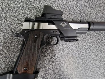 A modern handgun with attachments.
