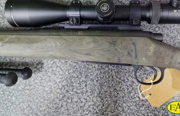 Close-up of a sniper rifle with a scope.