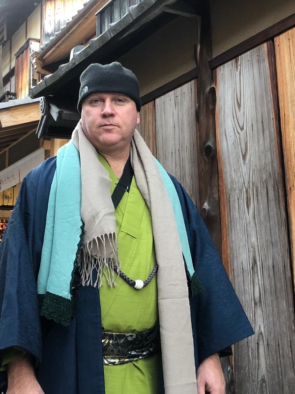 Man wearing traditional Japanese clothing and a beanie.