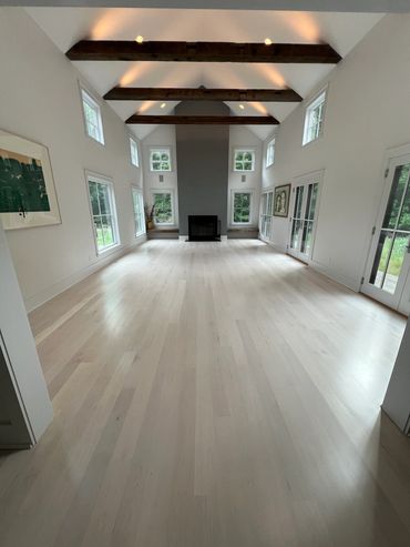 Spacious living room with high ceilings and exposed wooden beams.