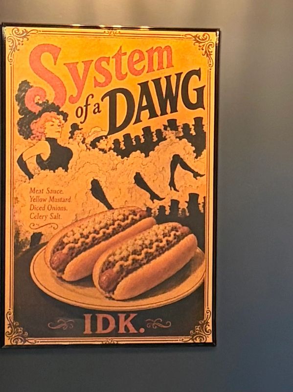 Vintage-style poster showing two hot dogs with dancers and the text 'System of a DAWG'.
