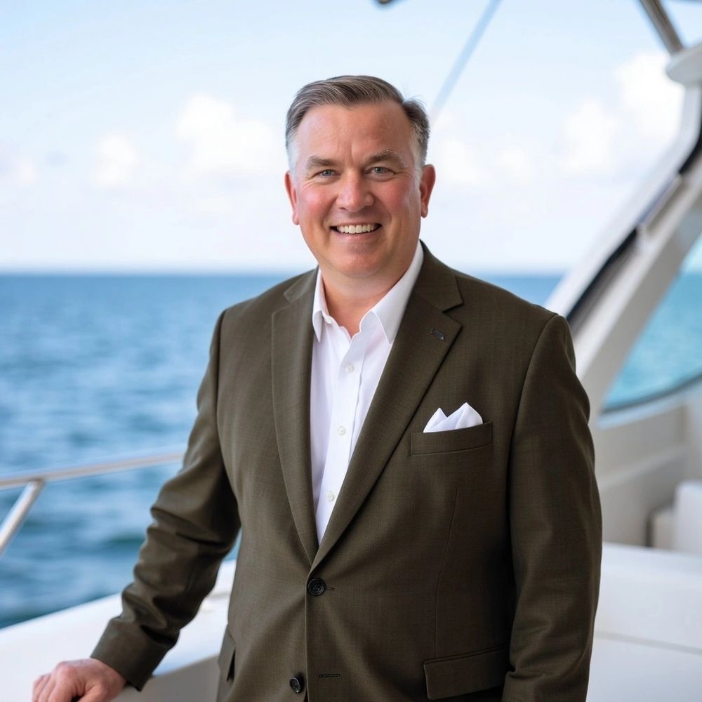 Stack of books next to pencils in a holder and a camera.