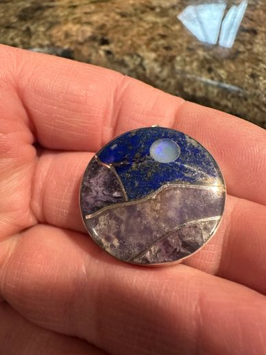 A sterling silver, lapis and amethyst pendant made using the Stone Inlay technique.