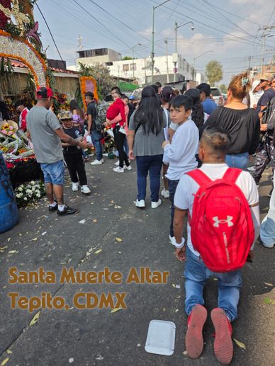 People gathered at Santa Muerte altar in Tepito, CDMX during a street event.