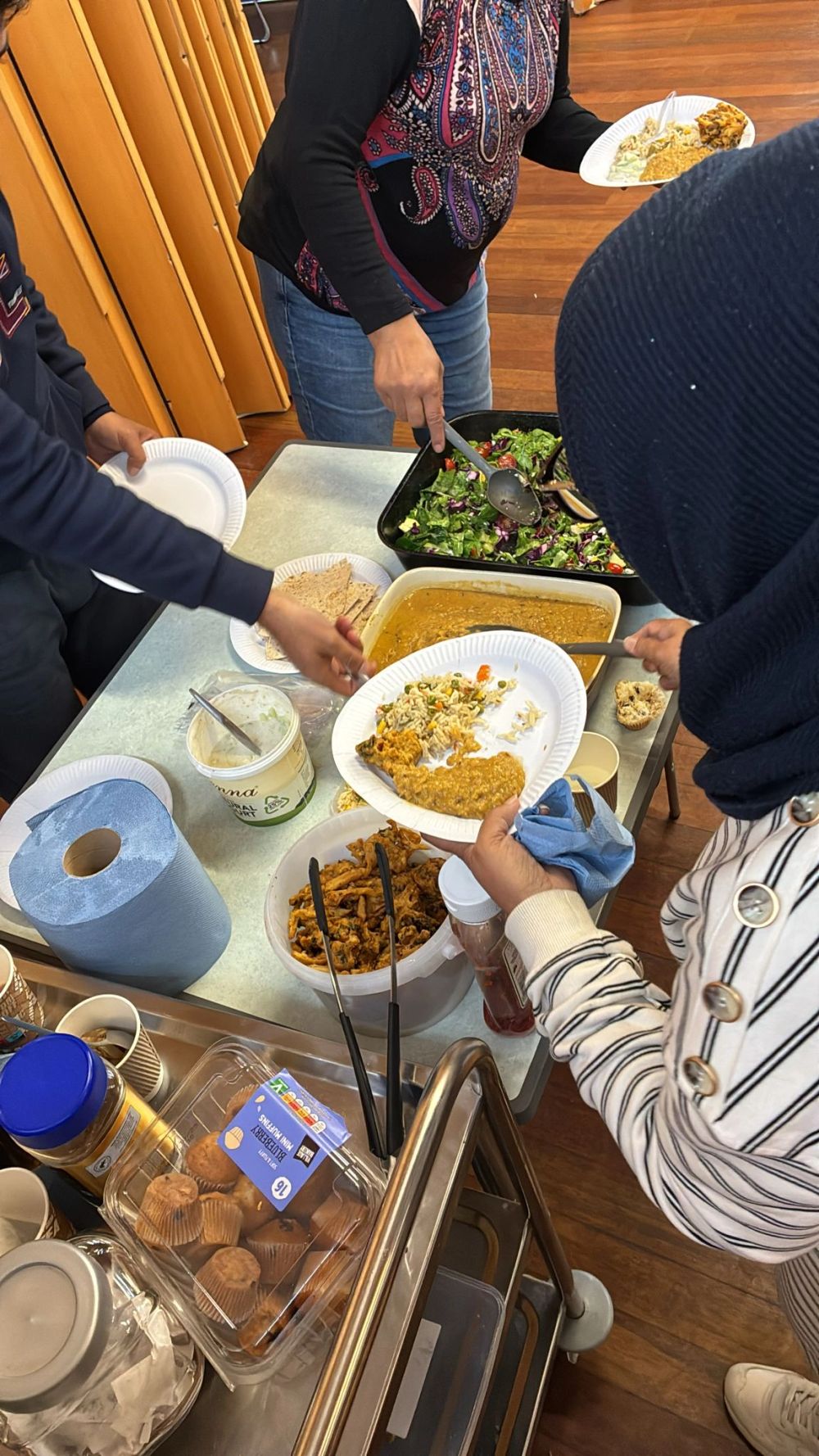 Community members serving and sharing healthy food at a Lets-Talk2day Healthy Horizons session.