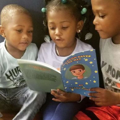 Three children reading a colorful book together.