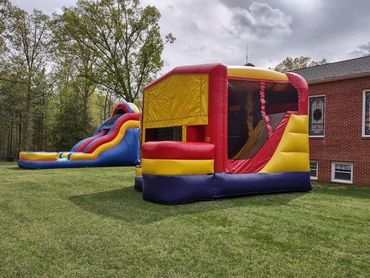 Yellow combo unit with jump area, ball hoop, and slide inside of it! Wet/dry slide in back ground. 