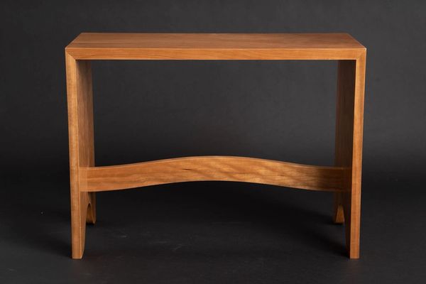 Curved cherry entry bench with hand cut dovetails.