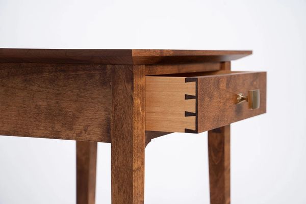 Alder furniture with dovetail drawer and brass knob hardware. 