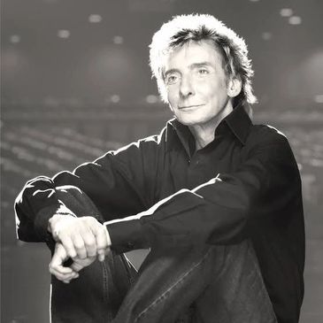 Black and white portrait of a man sitting.