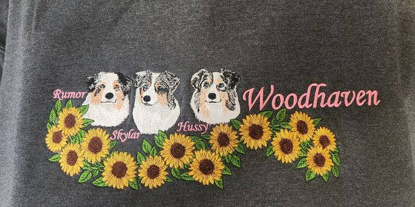 Three dog faces above sunflowers with names and 'Woodhaven' text.