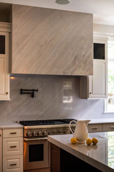 Modern kitchen with marble backsplash and countertop.