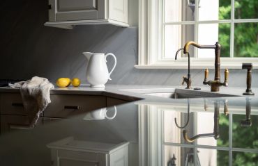 Modern kitchen corner with lemons and a white pitcher.