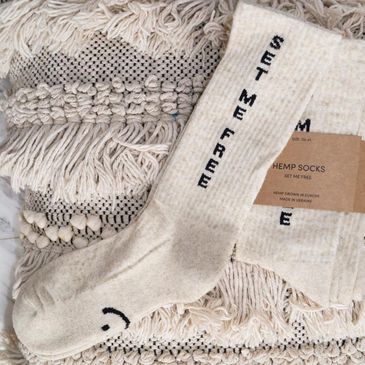 Set me free socks made from hemp displayed on a crochet blanket.