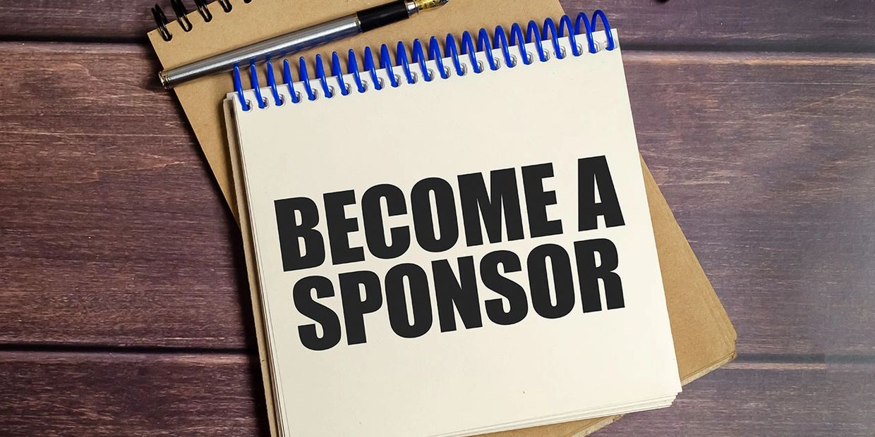 Notebook with bold text saying 'BECOME A SPONSOR'.