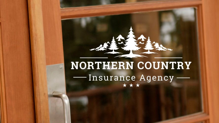 Glass door with a white Northern Country Insurance Agency logo featuring trees and stars.