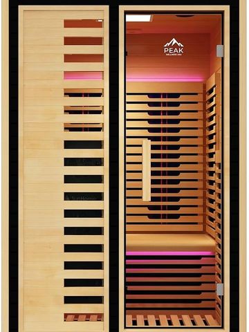 Modern wooden sauna with glass door and pink lighting.
