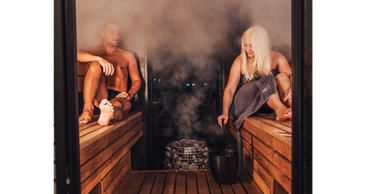 Two people enjoying a steamy sauna session.