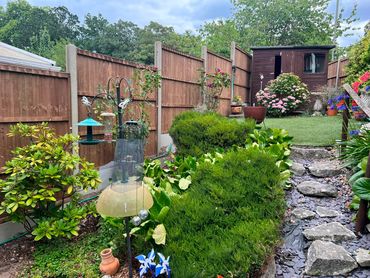 Closeboard fence panels with concrete posts and gravel boards