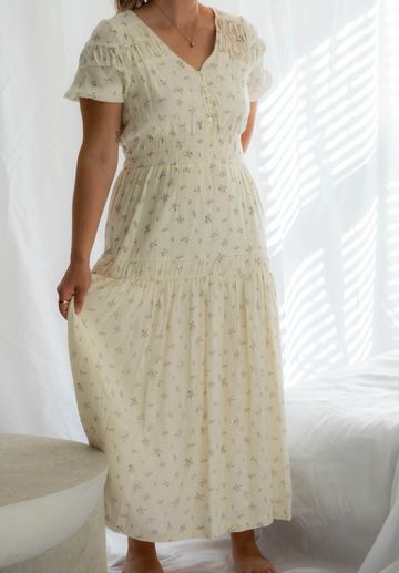 Woman wearing a light floral maxi dress.