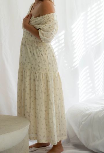Woman in a light floral off-shoulder dress.