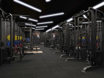 Modern gym with black workout machines and colorful weight plates.