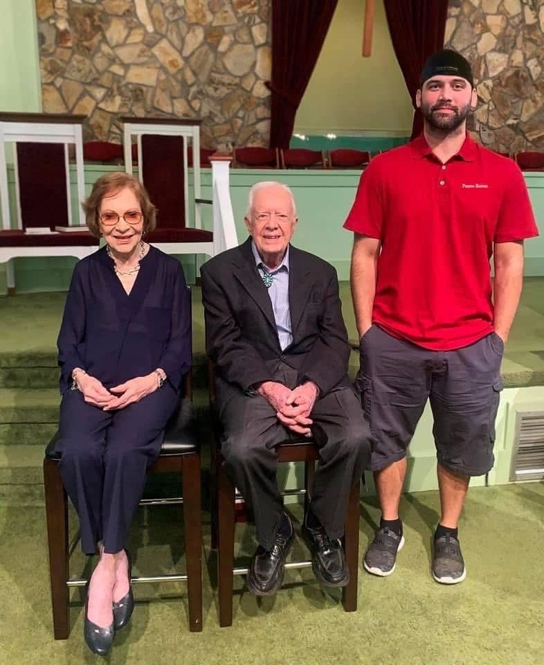 Logan Pearce presenting President Jimmy Carter with a knife.