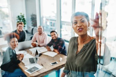 Group of employees in an office listening to a presentation.