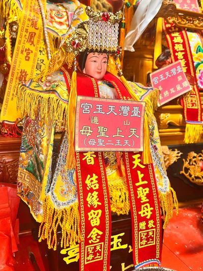 Colorful Chinese deity statue adorned with intricate robes and headdress.