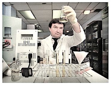 Scientist examining a liquid sample in a laboratory setting.