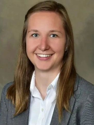 Young professional woman smiling.