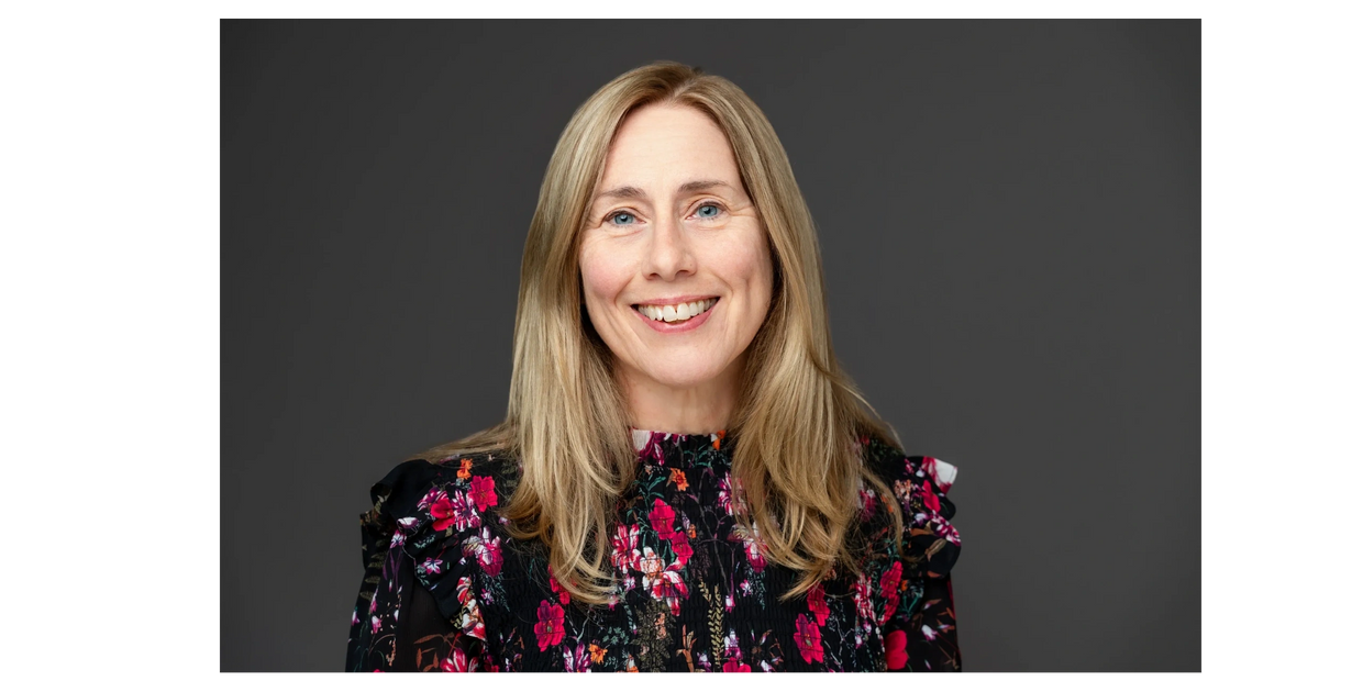 Colour photograph of Libby Graham with dark background 